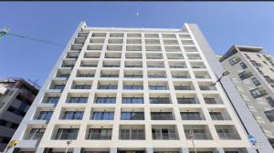 a tall white building with many windows at New CP Victory suites studio sleeps 4 with pool and gym in Gibraltar