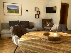 a living room with a table and a couch at Landhaus Engadin in Nauders