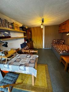 a room with a bed and a couch in it at Ski1600 - GrandMassif in Samoëns