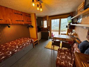 a bedroom with a bed and a table in a room at Ski1600 - GrandMassif in Samoëns