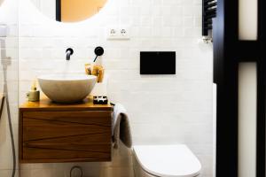 a bathroom with a sink and a toilet at Apartamentos Nevandi in Pido +167 photos