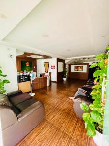 a living room with two people laying on couches at Oval Retreat in Cochin