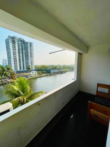 a balcony with a view of a river and buildings at Oval Retreat in Cochin