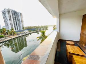 a balcony with a view of a river and buildings at Oval Retreat in Cochin +16 photos