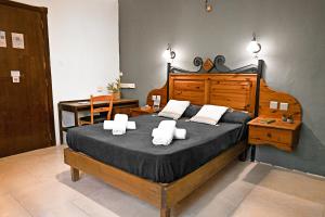 a bedroom with a large bed with towels on it at Sefranda Guesthouse in San Ġwann