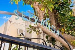 a sign for a store in front of a tree at Sefranda Guesthouse in San Ġwann +92 photos