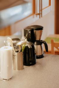 a kitchen counter with a coffee pot and a candle at Almhof Lässer in Balderschwang