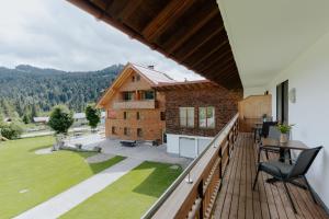 a balcony with a view of a house at Almhof Lässer in Balderschwang