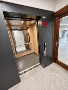 a elevator in a building with a glass door at Modern Studio with Sea View and Balcony in Middelkerke