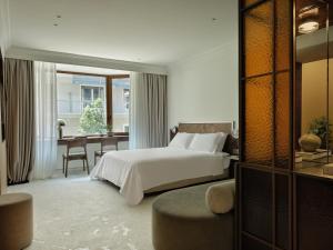 a hotel room with a bed and a dining room at The Newel Kolonaki in Athens +97 photos
