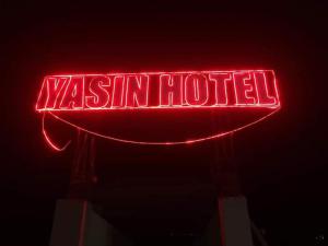 a neon sign that says westinothilus on it at Yasin Holiday Hotel in Gilgit