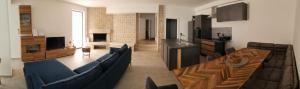 a living room with a blue couch and a table at Rose in Portorož