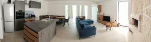a kitchen and living room with a couch and a table at Rose in Portorož