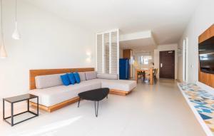 a living room with a couch and a table at Inturotel Esmeralda Villas in Cala d´Or +49 photos