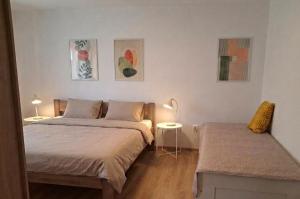 a bedroom with two beds and a table with a lamp at Ponte Liptov in Liptovský Trnovec