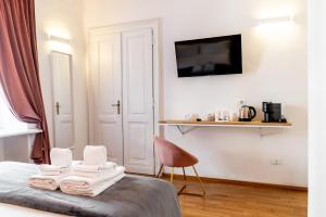 a bedroom with a bed with towels on it at Turin Central Suite in Turin