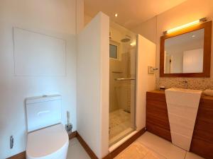 a bathroom with a toilet and a walk in shower at Beachfront Penthouse - Panoramic Ocean View in Cap Malheureux +17 photos