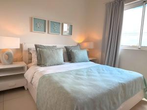 a bedroom with a large bed and a window at Beachfront Penthouse - Panoramic Ocean View in Cap Malheureux