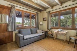 a living room with a couch and a table at Nuestro Antiguo Pajar in Solsona