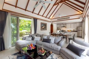 a living room with a couch and a table at Katamanda B2 Tropical Pool Villa Kata Beach in Kata Beach