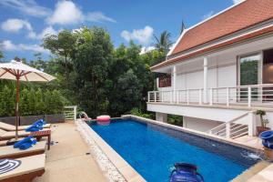 a swimming pool in front of a house at Katamanda B2 Tropical Pool Villa Kata Beach in Kata Beach
