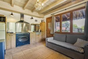 a kitchen with a couch and a stove at Nuestro Antiguo Pajar in Solsona +18 photos