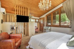 a bedroom with a bed and a chandelier at Nuestro Antiguo Pajar in Solsona