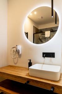 a bathroom with a white sink and a mirror at Turin Central Suite in Turin