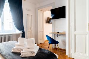 a room with a bed with towels on it at Turin Central Suite in Turin