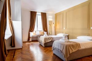 a bedroom with two beds and a window at Turin Central Suite in Turin +28 photos