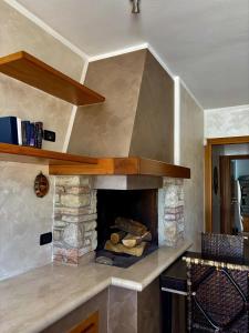 a kitchen with a stone fireplace in a kitchen at La Porta del Lugana - Albergo Quattro Pini in Pozzolengo