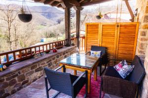 a patio with a table and chairs on a balcony at Apartamentos Nevandi in Pido