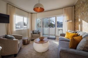 a living room with two couches and a table at Elegant Seaview Suite 1 in Swakopmund