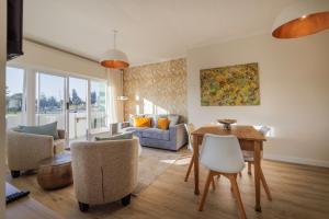 a living room with a table and chairs at Elegant Seaview Suite 1 in Swakopmund