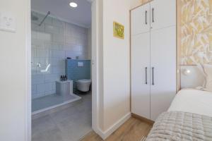 a bedroom with a shower and a bed and a bathroom at Elegant Seaview Suite 1 in Swakopmund +23 photos