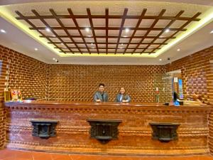 two people sitting at a bar in a building at Shine Boutique Hotel in Kathmandu +106 photos