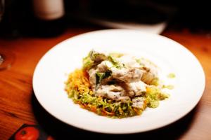 a white plate of food on a table at Coorg Mystere Luxury Home Stay in Madikeri