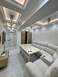 a living room with a couch and a table at Apartment Samarkand in Samarkand