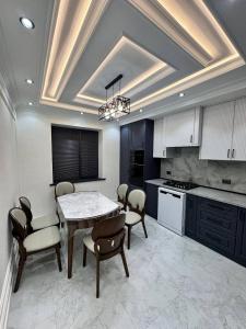a kitchen with a table and chairs in a room at Apartment Samarkand in Samarkand