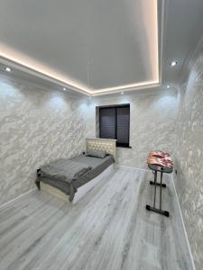 a bedroom with a bed and a tv on a wall at Apartment Samarkand in Samarkand