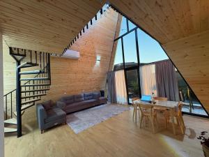 a living room with a couch and a table with a laptop at CottageNEO in Charnali