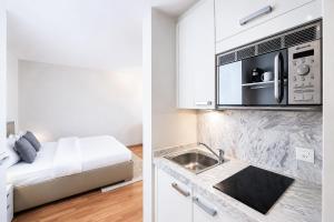 a kitchen with a sink and a microwave at VISIONAPARTMENTS Freyastrasse - self check-in in Zurich