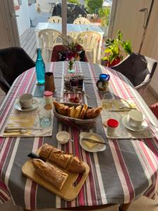 a table with bread and pastries on it at Le temps d une escapade vendéenne in Saint-Gervais