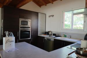 a kitchen with stainless steel appliances and a counter top at Villa A Liccia - Piscine & Vue Maquis - 8 Pers in Figari +43 photos