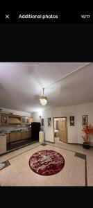 a large living room with a red rug on the floor at CH guest house in Murree