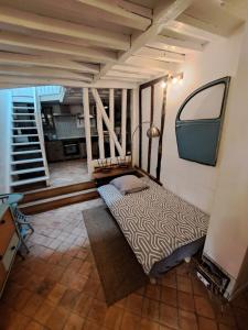 a room with a bed and a stair case at LA PETITE BEAUVAISIENNE in Beauvais