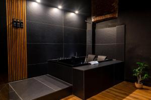 a black bathroom with a sink and a mirror at Turin Central Cavour in Turin +24 photos