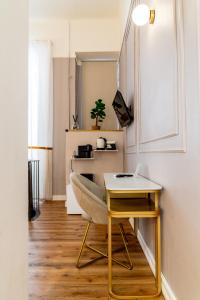 a living room with a table and a chair at Turin Central Cavour in Turin
