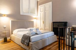 a bedroom with a bed with towels on it at Turin Central Cavour in Turin