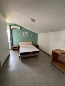 a large room with a bed and a table at Hôtel 2 Étoiles centre ville in Mont-de-Marsan